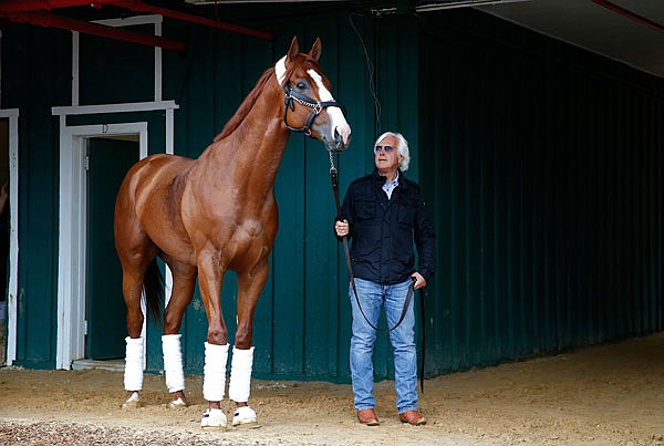 Trainer Bob Baffert walks Kentucky Derby winner Justify in a barn Wednesday after arriving at Pimlico Race Course in Baltimore.