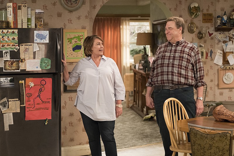 This image released by ABC shows Roseanne Barr, left, and John Goodman in a scene from the comedy series "Roseanne." Expect "Roseanne" to cool it on politics and concentrate on family stories when it returns for the second season of its revival next year. ABC Entertainment chief Channing Dungey noted that as the first season went on, the focus shifted from politics to family. She said that direction will continue next season. (Adam Rose/ABC via AP)