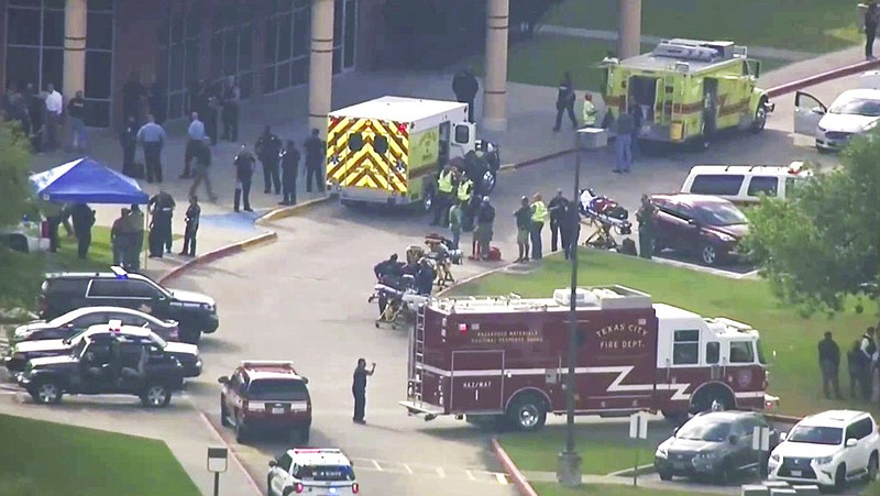 In this image taken from video emergency personnel and law enforcement officers respond to a high school near Houston after an active shooter was reported on campus, Friday, May 18, 2018, in Santa Fe, Texas. The Santa Fe school district issued an alert Friday morning saying Santa Fe High School has been placed on lockdown.