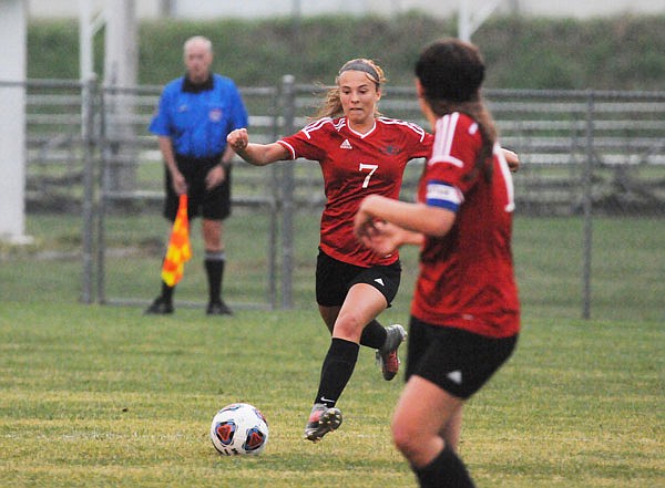 Jefferson City's Daelynn Scheulen passes the ball ahead to a teammate during Thursday's Class 4 District 9 Tournament game against Rock Bridge at the 179 Soccer Park.