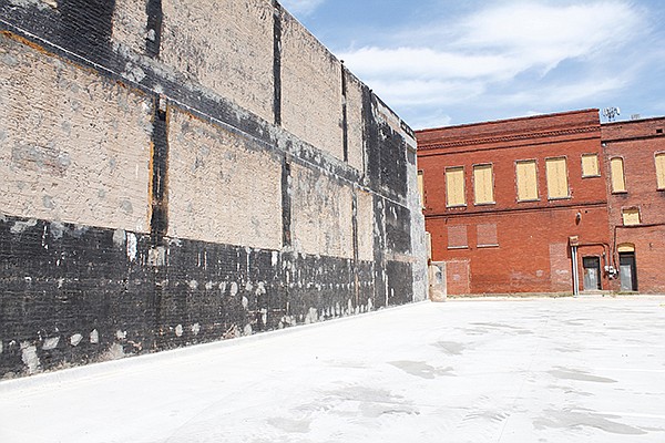 A wall of an adjacent building stands Friday, May 18, 2018, where a Kress department store once was at 116 W. Broad St. in Texarkana, Texas. Texarkana Arts and Historic District is recruiting artists to put mini-murals on the walls on either side of the lot. 