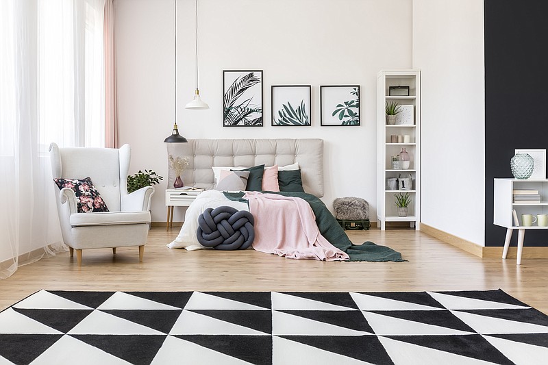 A mix of bold patterns, moody colors and nature-inspired accents makes this bedroom perfectly on trend. (Dreamstime)