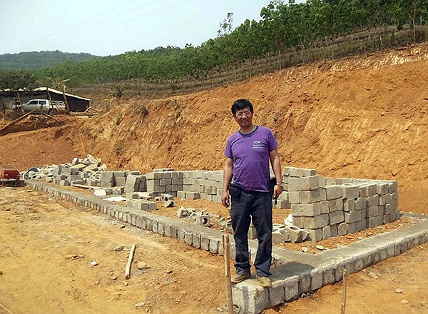 In this May 2014, photo released by Ben Cao, Rev. John Sanqiang Cao breaks a ground on a new school in Wa State, Myanmar. The prominent Chinese pastor who has been detained by Chinese authorities since March 5, 2017 was sentenced in March 2018 to seven years in prison for "organizing others to illegally cross the border." 