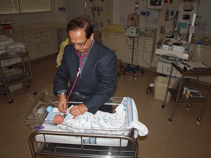 Arun Narula, M.D., neonatologist, checks on a premature baby in the Level II Wadley Neonatal Intensive Care Unit. (Submitted photo)