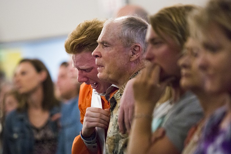 Nathan Jordan, 18, a senior student at Alvin High School sobs during a service at the Arcadia First Baptist Church two days after a shooting that killed 10 people at the Santa Fe High School, Sunday, May 20, 2018, in Santa Fe, Texas. (Marie D. De Jesus/Houston Chronicle via AP)