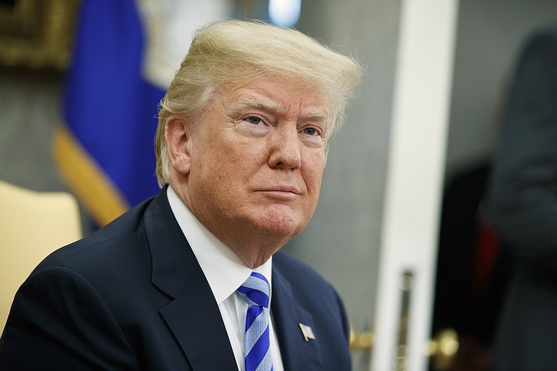 File - In this May 16, 2018, file photo, President Donald Trump listens to a question during a meeting in the Oval Office of the White House in Washington. Trump says he'll demand that the Justice Department review whether it or the FBI infiltrated his campaign and whether any demands came from the Obama administration. Trump tweeted Sunday, May 20: "I hereby demand, and will do so officially tomorrow, that the Department of Justice look into whether or not the FBI/DOJ infiltrated or surveilled the Trump Campaign for Political Purposes." (AP Photo/Evan Vucci, File)