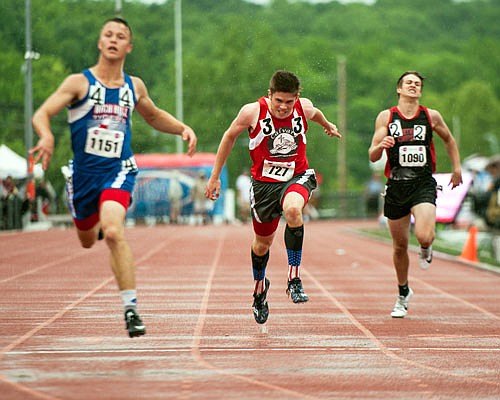 Reece Going (center) of Calvary Lutheran pushes himself to the finish line in the Class 1 boys 200-meter dash finals Saturday at Adkins Stadium.