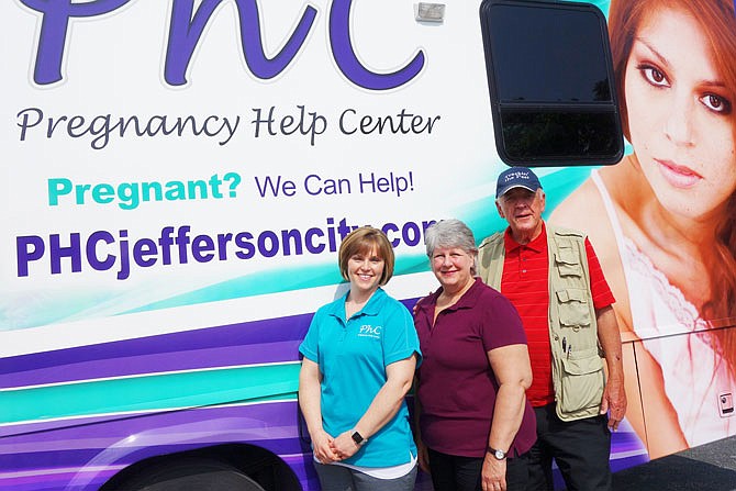 Pregnancy Help Center Assistant Director Audrea George, left, along with client advocate Jeannine Schaefer, her sister (not pictured) and bus driver Mike Wiseman, brought the center's brand-new mobile unit to Fulton on Wednesday. The mobile unit offers free pregnancy tests and ultrasounds.
