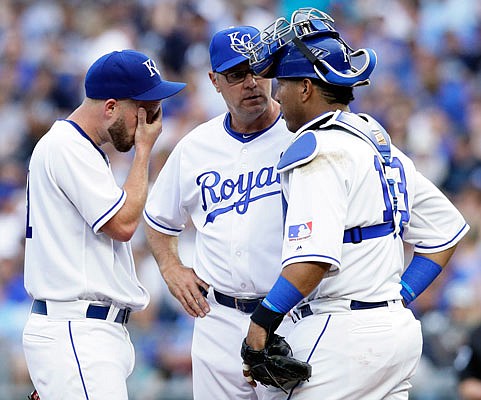 Royals starting pitcher Danny Duffy (left) meets with pitching coach Cal Eldred and catcher Salvador Perez after giving up a three-run home run during the fifth inning of Saturday night's game against the Yankees at Kauffman Stadium.