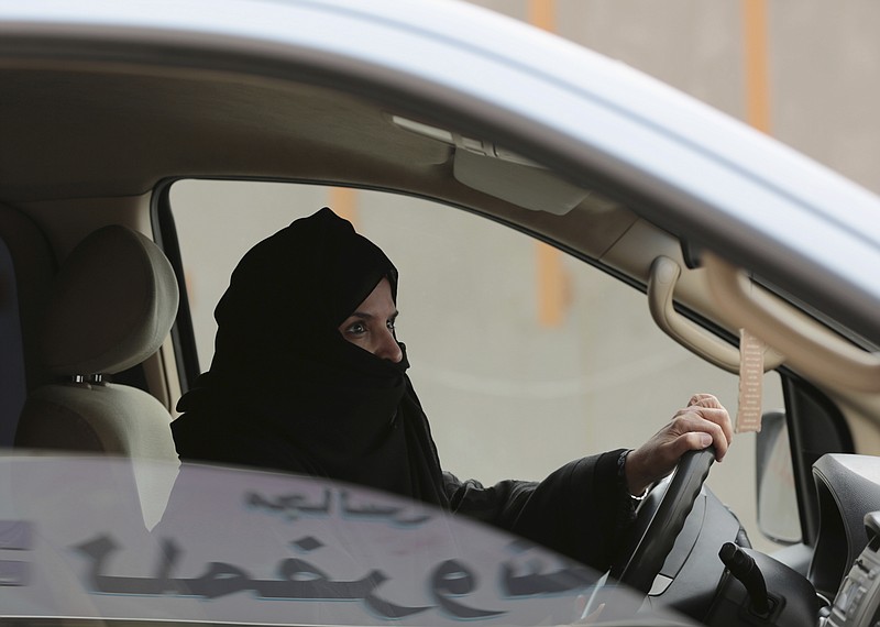 In this March 29, 2014 file photo, Aziza al-Yousef drives a car on a highway in Riyadh, Saudi Arabia, as part of a campaign to defy Saudi Arabia's ban on women driving. Saudi authorities have detained at least six activists, including three of the country's most prominent women's rights campaigners, just weeks before the kingdom is set to lift a ban on women driving, people familiar with the arrests said Friday, May 18, 2018. (AP Photo/Hasan Jamali, File)