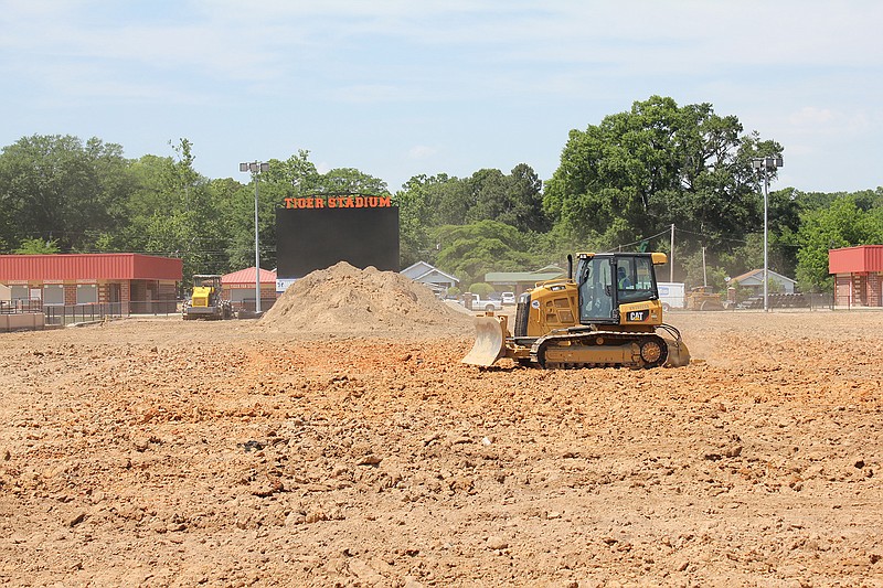 A worker prepares a section of Tiger Stadium on Friday in Texarkana. The work is part of a $2.6 million project to replace the stadium's grass with turf. Turf will also be placed at the multipurpose facility and at Texas High, where a new track will be constructed. Work is expected to be complete by mid-August.