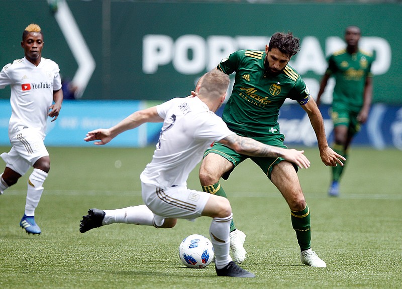 Portland Timbers' Diego Valeri (8) tries to dribble past LAFC's Jordan Harvey (2) during an MLS soccer game, Saturday, May 19, 2018, in in Portland, Ore. (Sean Meagher//The Oregonian via AP)