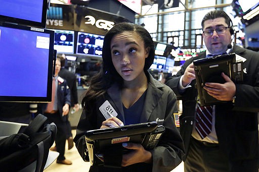 Trader Lauren Simons works on the floor of the New York Stock Exchange, Monday, May 21, 2018. Stocks are opening solidly higher on Wall Street after trade tensions between the U.S. and China dissipated. (AP Photo/Richard Drew)