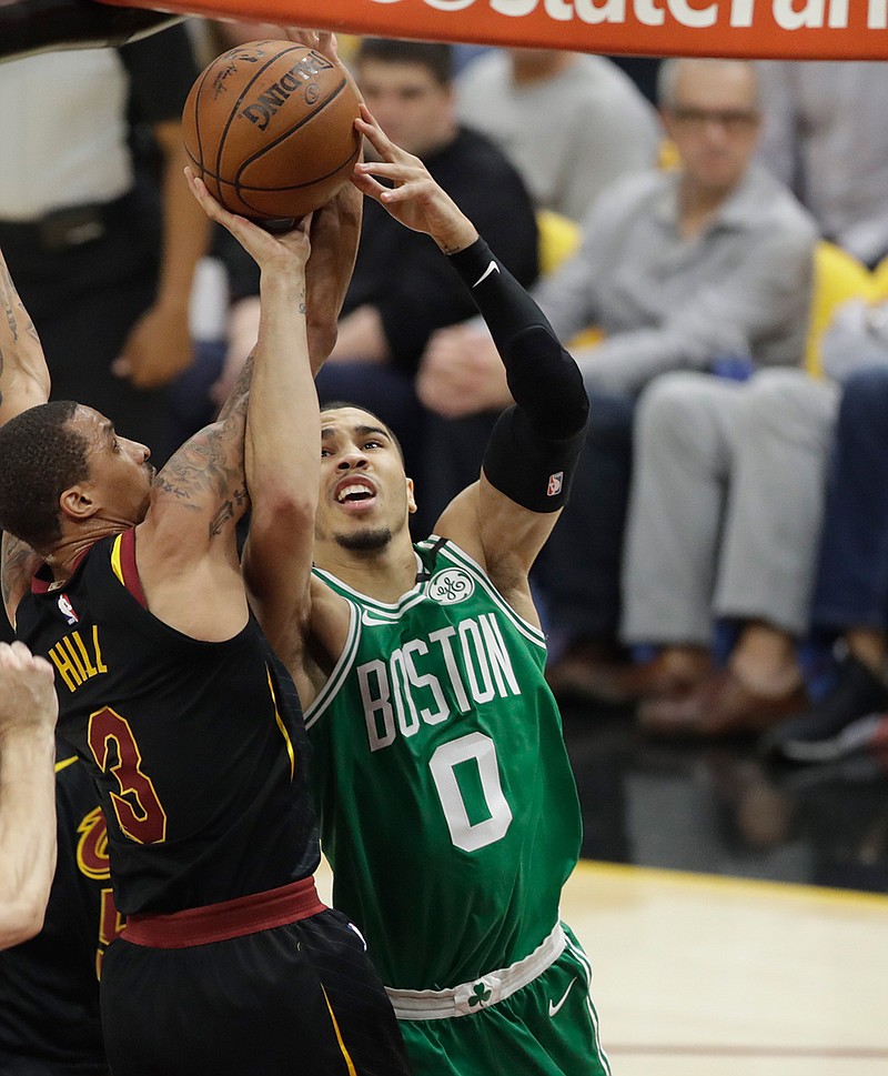 Boston Celtics' Jayson Tatum (0) drives to the basket as Cleveland Cavaliers' George Hill (3) defends in the first half of Game 3 of the NBAl Eastern Conference finals Saturday in Cleveland. 