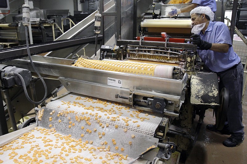 In this Jan. 14, 2009 file photo, Sweethearts candy drop onto a conveyor belt as they are manufactured at the New England Confectionery Company in Revere, Mass. (AP Photo/Charles Krupa, File)