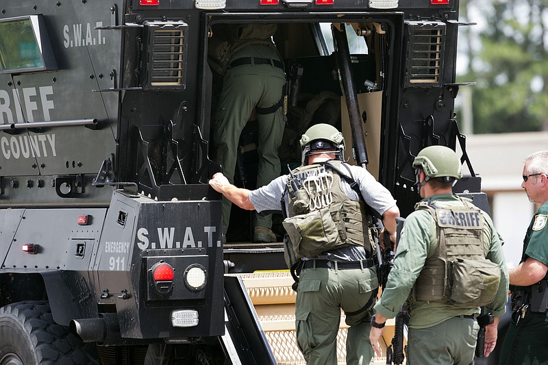 Bay County Sheriff's Office deputies enter an armored vehicle at the corner of 23rd Street and Beck Avenue, Tuesday, May 22, 2018, in Panama City, Fla., in response to an active shooter in the area. (Joshua Boucher/News Herald via AP)