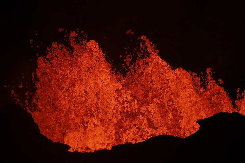 Lava erupts from a fissure in Kapoho, Hawaii Monday, May 21, 2018. The eruption of Kilauea volcano in Hawaii sparked new safety warnings about toxic gas on the Big Island's southern coastline after lava began flowing into the ocean and setting off a chemical reaction. (AP Photo/Jae C. Hong)