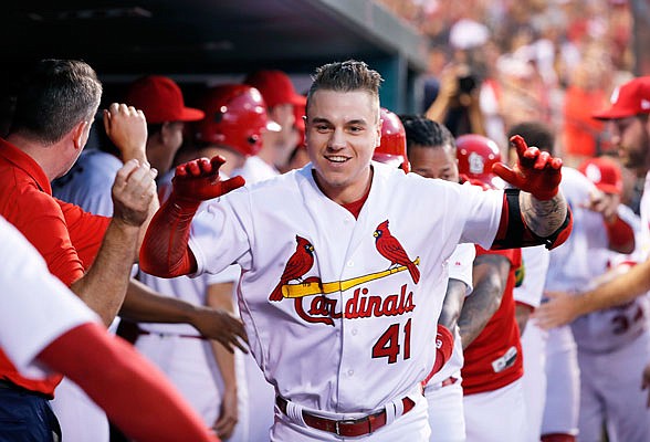 Tyler O'Neill of the Cardinals is congratulated in the dugout after hitting a three-run home run in the third inning of Monday night's game against the Royals at Busch Stadium.