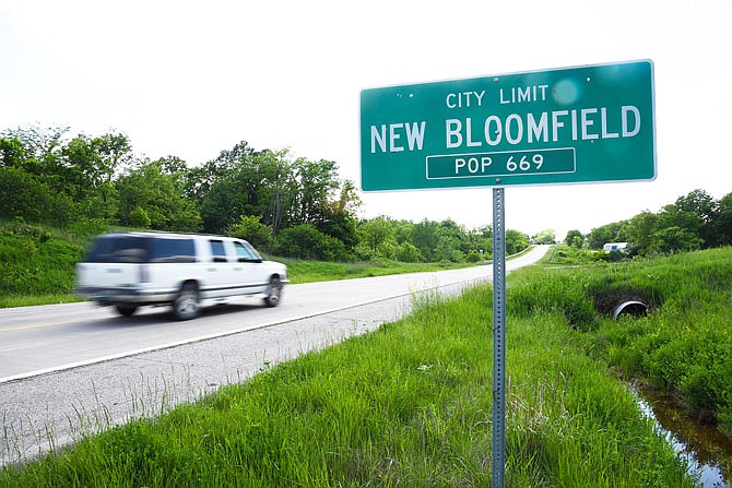 A car speeds past the city limit sign for New Bloomfield.