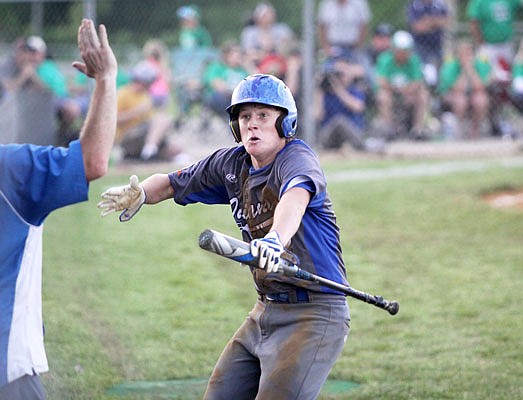 Russellville's Trent Morrow celebrates on his way back to the dugout after scoring a run in the top of the ninth inning of Monday's Class 2 sectional game against Iberia at Hoover Field.