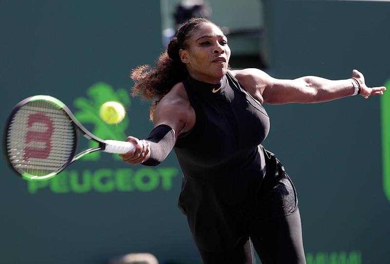 Serena Williams returns to Naomi Osaka of Japan during the Miami Open tennis tournament on March 21 in Key Biscayne, Fla. Several of Serena Williams' biggest rivals believe that the 23-time Grand Slam champion deserves more than just a guaranteed spot in the French Open draw. Williams, who is expected to play her first major since returning from maternity leave, should also receive a top seed that befits the No. 1 ranking she held when she left the tour, the players say. (Lynne Sladky/Associated Press file photo)