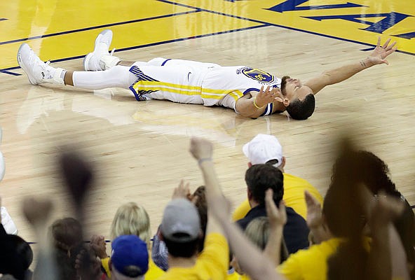 Stephen Curry of the Warriors celebrates after scoring during Sunday's game against the Rockets in Oakland, Calif.