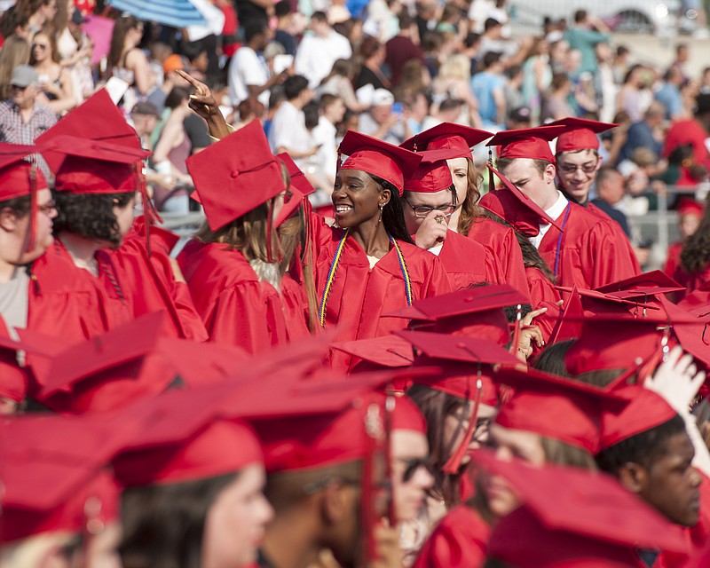 
Members of the Jefferson City High School graduating class wave to family and friends as they take their seats at the start of the commencement exercise held at Adkins Football Stadium on Sunday, May 13, 2018.
