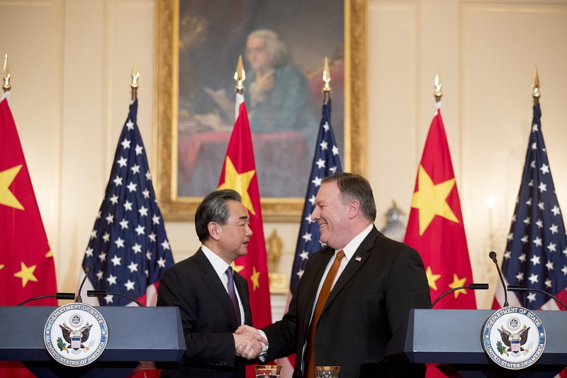 Secretary of State Mike Pompeo and Chinese State Councilor and Foreign Minister Wang Yi shake hands following a news conference at the State Department, Wednesday, May 23, 2018, in Washington. (AP Photo/Andrew Harnik)