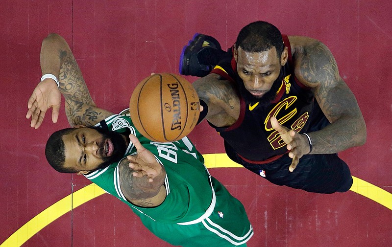Cleveland Cavaliers' LeBron James, right, drives to the basket against Boston Celtics' Marcus Morris in the second half of Game 4 of the NBA basketball Eastern Conference finals, Monday, May 21, 2018, in Cleveland. The Cavaliers won 111-102. (AP Photo/Tony Dejak)