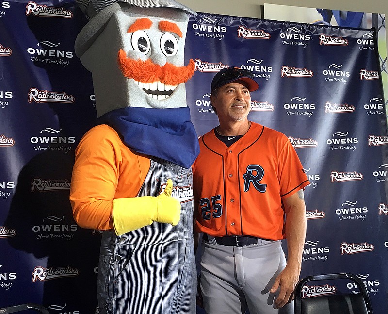 In this Thursday, May 10, 2018, file photo, the Cleburne Railroaders mascot, Spike, left, poses with former Major League Baseball player and newly-signed player Rafael Palmeiro, right, after a news conference where Palmeiro was introduced in Cleburne, Texas. Palmeiro still has power, even at 53. After hitting more than 500 home runs in the major leagues, Palmeiro homered Monday, May 21, 2018, for the first time in his return to baseball with the independent Cleburne Railroaders. (AP Photo/Stephen Hawkins, File)