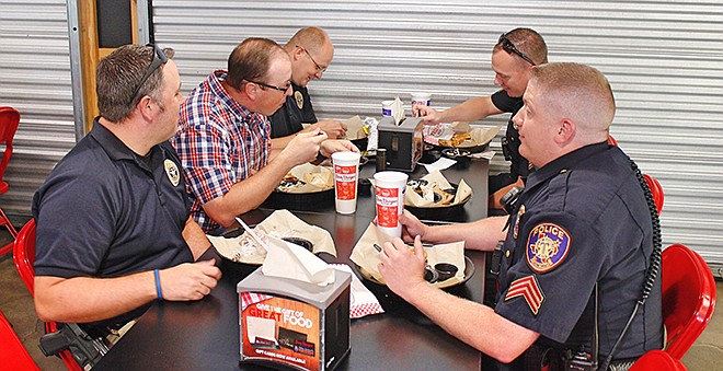 Texarkana, Texas, Police Sgt. Micah Brower, from left, Cpl. Geoff Lewis, Officer Jeremy Sutton, Sgt. Jeremy Courtney and Sgt. Greg Walker eat a free lunch Wednesday, May 23, 2018, at Big Jake's Bar-B-Que on Richmond Road. To show first responders appreciation for their service, Big Jake's and First Baptist Church, Moores Lane, served them free meals on Wednesday. Texarkana Emergency Center, Fox Sports Radio 1400, Farmers Bank and Trust and LifeNet sponsored the event.