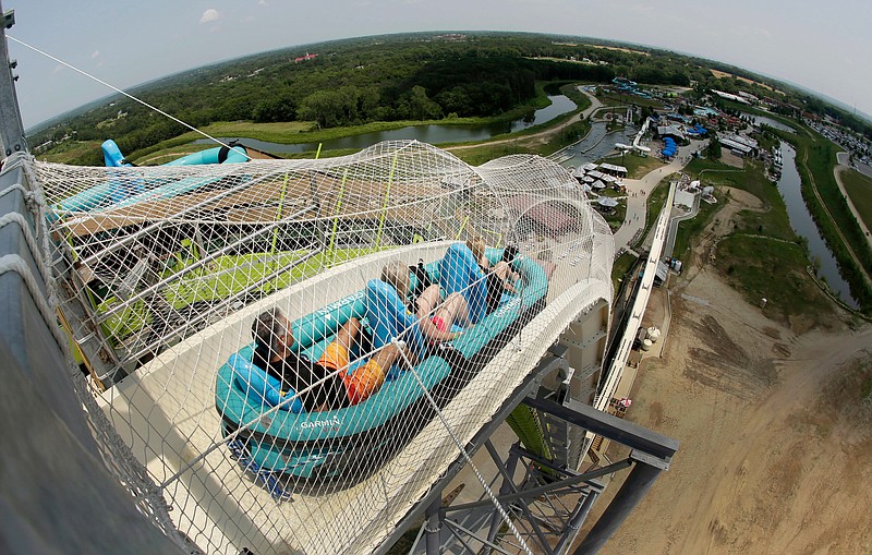 FILE - In this July 9, 2014, file photo, riders go down the water slide called "Verruckt" at Schlitterbahn Waterpark in Kansas City, Kan. A state inspection has found 11 alleged violations of regulations at the Kansas water park where a 10-year-old boy died in 2016. The Kansas Department of Labor made an audit of the Schlitterbahn park in Kansas City public Tuesday, May 22, 2018, a day after issuing a notice to the park. The audit said safety signs in some park areas were not adequate, records were not available for review and some operating and training manuals were not complete. (AP Photo/Charlie Riedel, File)