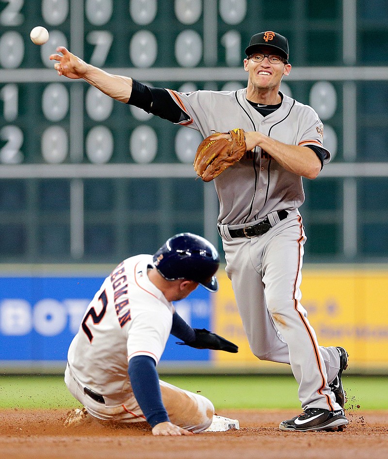 Houston Astros Alex Bregman (2) is out at second base as San Francisco Giants second baseman Kelby Tomlinson tries to turn the double play Wednesday during the fifth inning in Houston. (Associated Press)