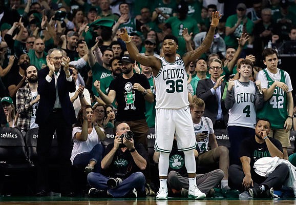 Celtics guard Marcus Smart celebrates near the end of Wednesday night's Game 5 win against the Cavaliers in Boston.
