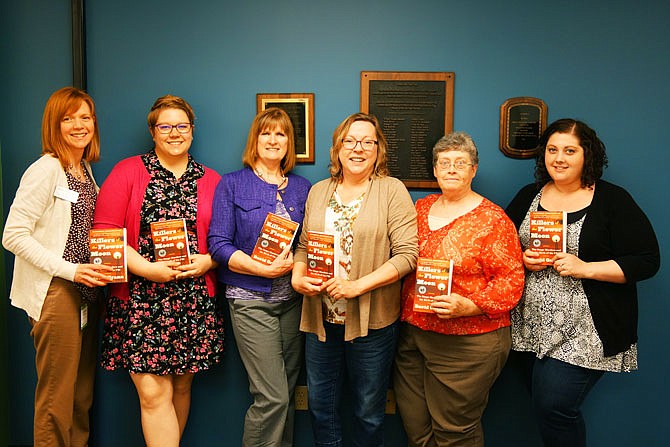 Members of the 2018 One Read Tak Force hold copies of this year's book pick: "Killers of the Flower Moon" by David Grann. Members pictured include, from left, Lauren Williams, Kat Stone Underwood, Mitzi St. John, Tonya Hayes Martin, Angela Grogan and Jill Mahoney.