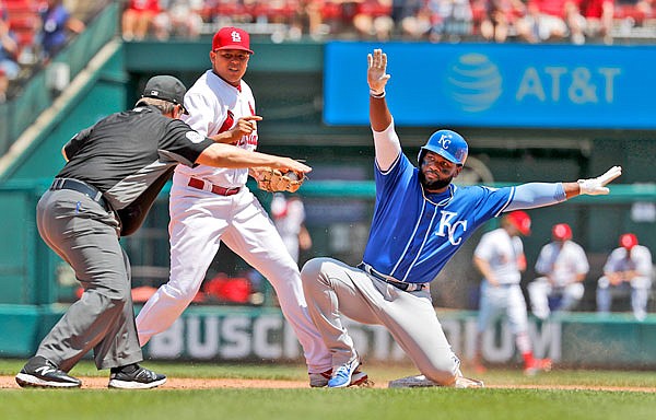 Abraham Almonte of the Royals is safe at second base as umpire Doug Eddings makes the call and Cardinals shortstop Yairo Munoz stands by during the second inning of Wednesday afternoon's game at Busch Stadium.