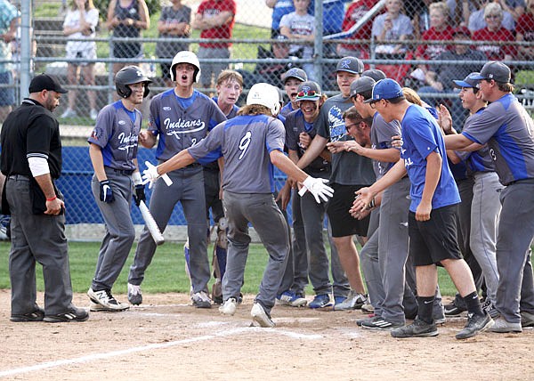 Russellville players wait at home plate to greet Austin Roe (center) after he hit a solo home run in the sixth inning of Wednesday's game against Canton in the Class 2 quarterfinals at Russellville.