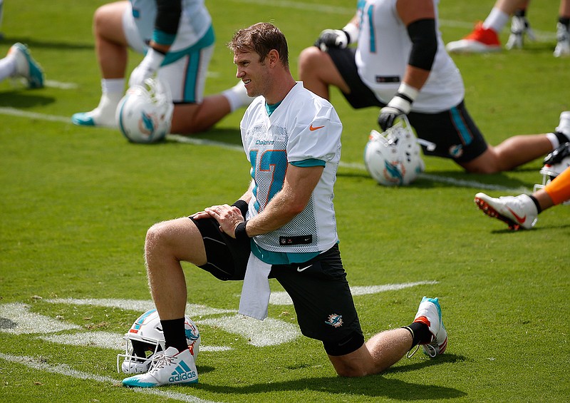 Miami Dolphins quarterback Ryan Tannehill stretches during practice  Wednesday at the Dolphins training facility in Davie, Fla. Tannehill returns to the Dolphins' practice field this week for OTAs, optimistic he can stay healthy after suffering a serious knee injury each of the past two years. (Associated Press)
