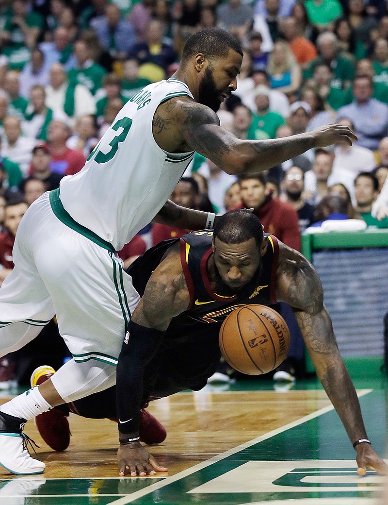 Cleveland Cavaliers forward LeBron James (23) loses the ball out of bounds under defensive pressure from Boston Celtics forward Marcus Morris (13) during the first quarter of Game 5 of the NBA basketball Eastern Conference finals Wednesday, May 23, 2018, in Boston. (AP Photo/Charles Krupa)