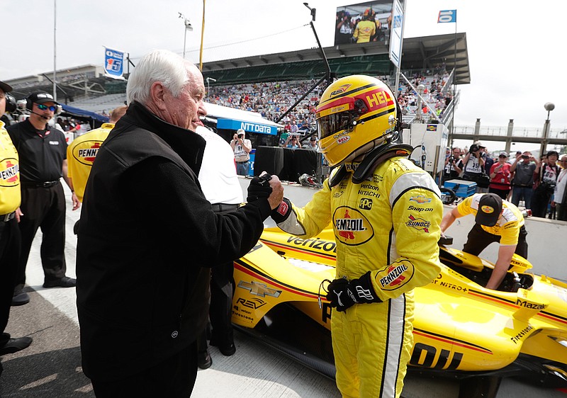 Helio Castroneves, of Brazil, is congratulated by car owner Roger Penske after he qualified for the IndyCar Indianapolis 500 auto race at Indianapolis Motor Speedway in Indianapolis, Saturday, May 19, 2018. (AP Photo/Michael Conroy)