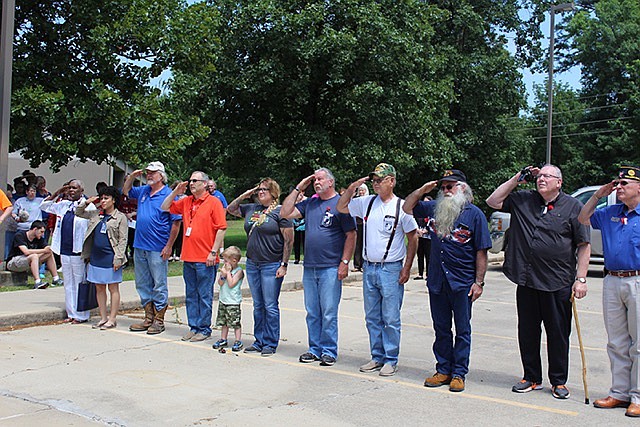 Veterans from Opportunities, Inc, American Legion, and Vietnam Veteran's Association saluted the flag during a Memorial Day celebration on Thursday at the Opportunities, Inc. Senior Day Center. Pictured, from left: Carla Wages, Cornelia Keeton, Bobby Click, Andy Anderson, Kari Valentine, Greg Beck, Richard Harland, Michael O'Neal, Don Nicholson and Wendell Vanhook. (Submitted photo)