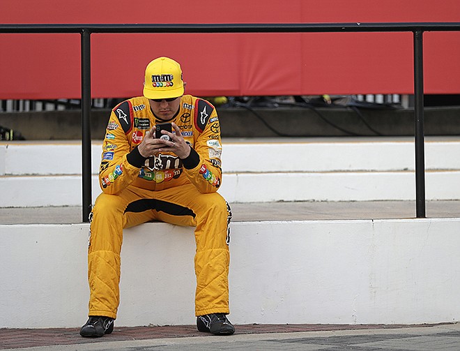 Kyle Busch waits in Victory Lane after winning the pole position for the NASCAR Cup series auto race at Charlotte Motor Speedway in Charlotte, N.C., Thursday, May 24, 2018. 