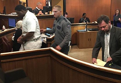 Texas prison inmate Bryan White is escorted from a courtroom at the Bowie County courthouse in New Boston following a pretrial hearing May 24 before 102nd District Judge Bobby Lockhart. White is accused of assaulting a correctional officer Jan. 3 at the Barry Telford Unit in New Boston. Also pictured right is White's defense lawyer, Jeff Harrelson of Texarkana.

