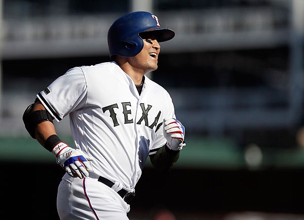 Shin-Soo Choo of the Rangers celebrates his walk-off home run during the 10th inning of Saturday afternoon's game against the Royals in Arlington, Texas. 