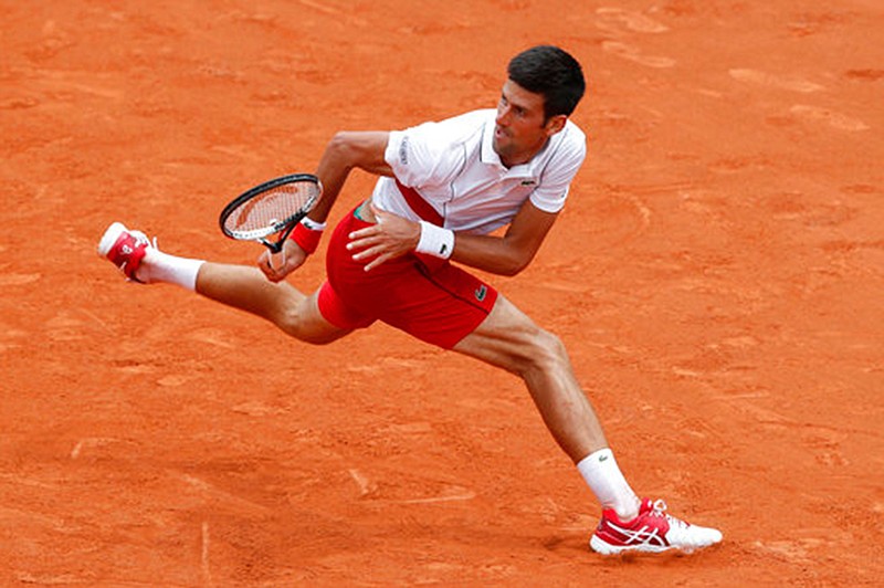 Serbia's Novak Djokovic keeps his eye on the ball as he returns a shot against Brazil's Rogerio Dutra Silva during their first-round French Open match Monday at the Roland Garros stadium in Paris. (Associated Press)