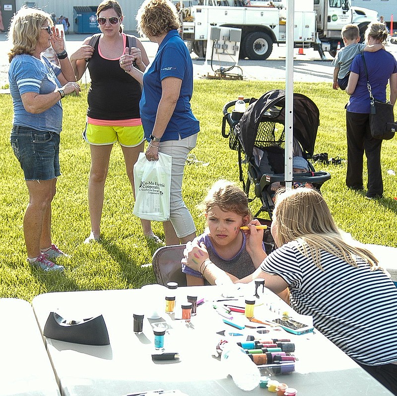 <p>Democrat photo </p><p>David A. Wilson</p><p>Everley Scheidt gets her face painted before the 2018 Co-Mo Electric meeting starts. Her mother and grandmother are among those behind her.</p>