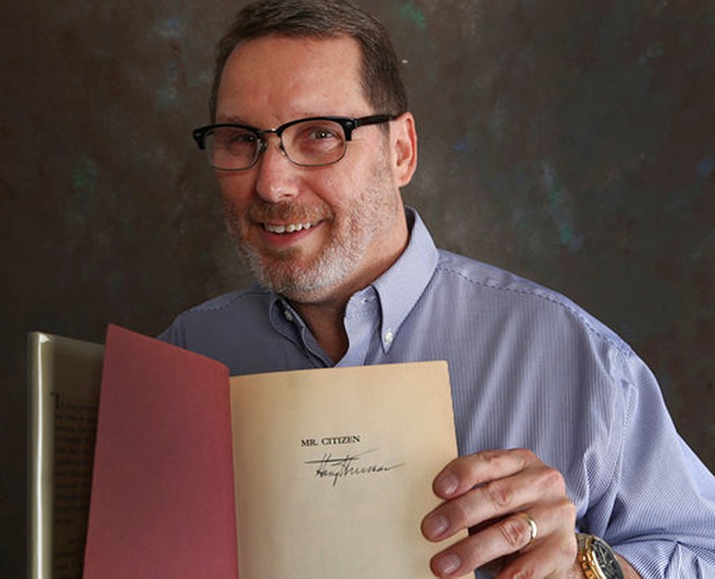 In this Saturday, May, 19, 2018 photo, Waco ISD social studies specialist Robert Glinski holds a signed copy of Harry S. Truman's 1960 memoir, "Mr. Citizen" found last week in the Waco High School's library in Waco, Texas. (Rod Aydelotte/Waco Tribune-Herald via AP)