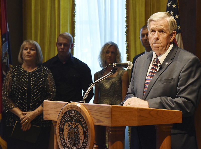 Gov. Mike Parson listens as a reporter asks a question of him after he was sworn in as the 57th governor of Missouri on Friday, June 1, 2018.