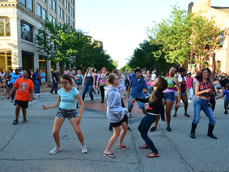 Mark Wilson/News Tribune
Dancers sway to the music of DJ Curt on a hot evening during Thursday Night Live!  The outdoor summer concert series was presented by Central Bank. 