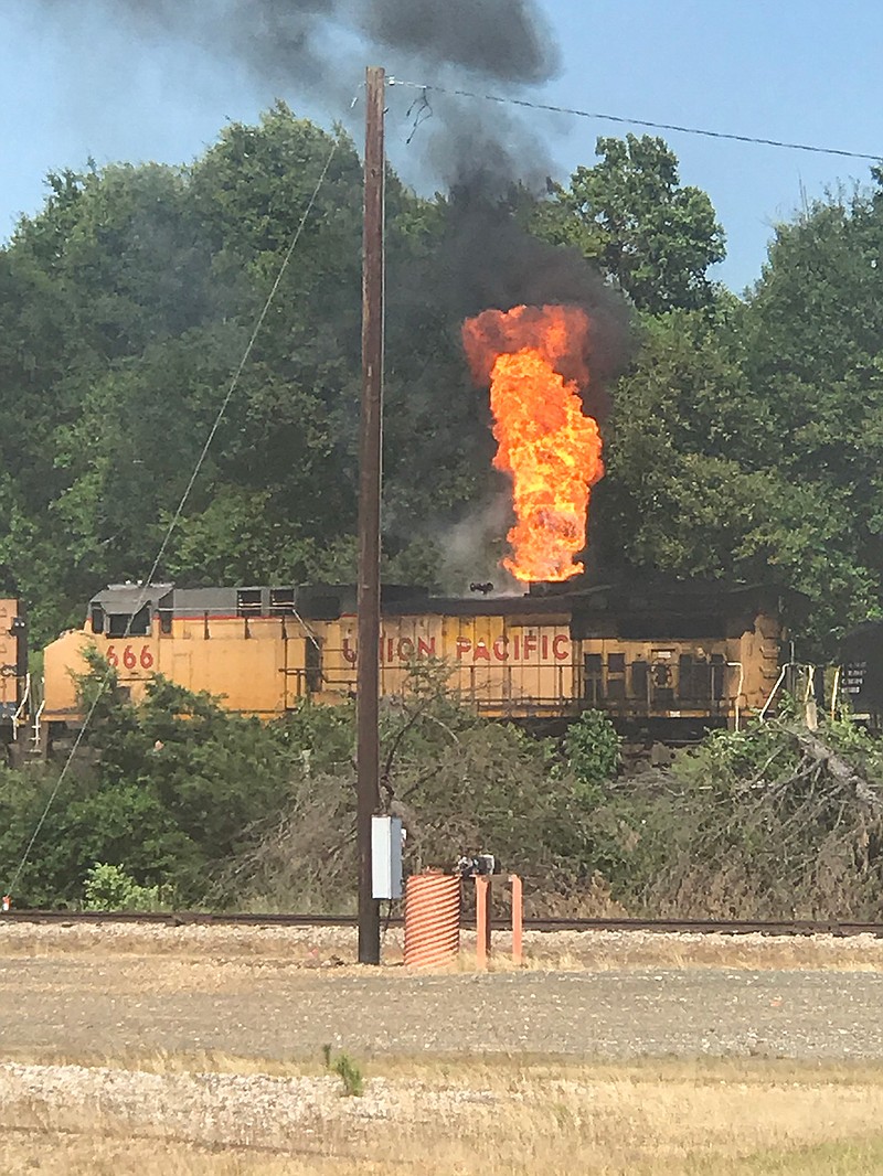 Flames shoot up from a Union Pacific locomotive traveling Thursday afternoon through Texarkana. Officials say a mechanical malfunction caused the oil fire. (Photo courtesy of Shawn Vaughn/Texarkana, Texas, Police Department)
